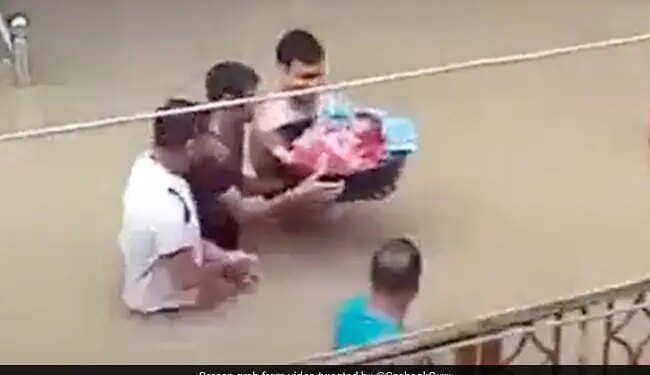 Man Walks Through Deep Water To Bring Newborn Baby Home Amid Assam Floods Watch Viral Video