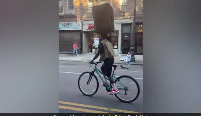 This Man Is Riding A Bicycle With A Suitcase On His Forehead, You Will Be Surprised To See The Video