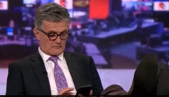 BBC Anchor Scrolling On Phone With Feet Up On Desk Mid Live Broadcast Caught On Camera