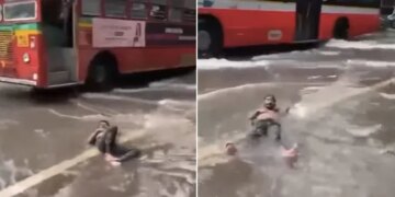 Man Lying Comfortably On A Waterlogged Street Amid Mumbai Rains Internet Says Feeling Maldives In Malad See Viral Video – मुंबई की बारिश में पानी से भरी सड़क पर आराम से लेटकर चिल करते दिखा शख्स, लोग बोले