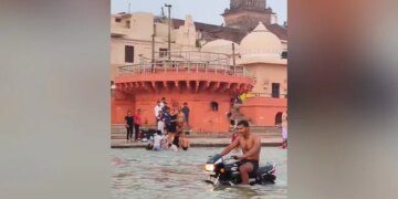 Viral Video: Man Drives Bike Inside Holy River Saryu In Ayodhya, People Get Angry