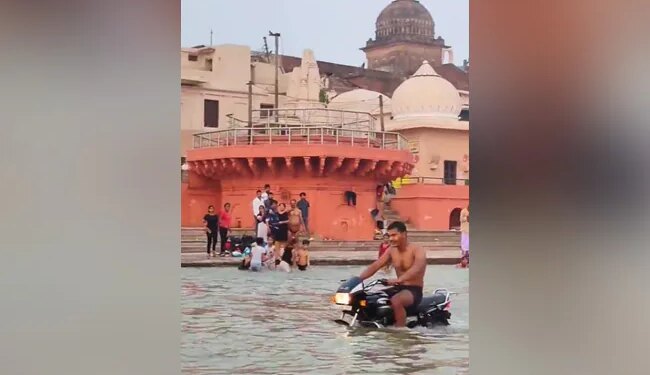 Viral Video: Man Drives Bike Inside Holy River Saryu In Ayodhya, People Get Angry