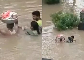 Man Carries Baby In A Tub During Flood | Man Enter In Flood Water With The Kid On His Head Video Viral