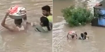 Man Carries Baby In A Tub During Flood | Man Enter In Flood Water With The Kid On His Head Video Viral