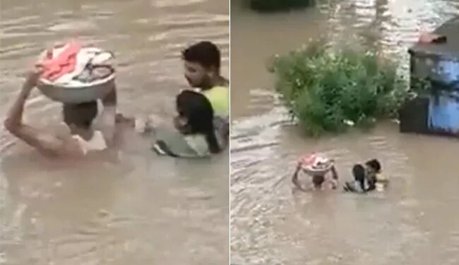 Man Carries Baby In A Tub During Flood | Man Enter In Flood Water With The Kid On His Head Video Viral