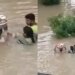 Man Carries Baby In A Tub During Flood | Man Enter In Flood Water With The Kid On His Head Video Viral