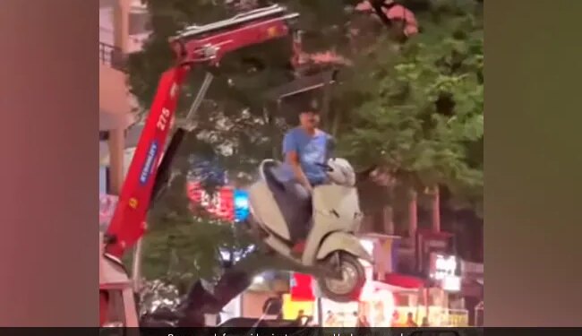 Man Sits On Scooter As It Hangs In Air While Getting Towed In Nagpur See Bizarre Viral Video