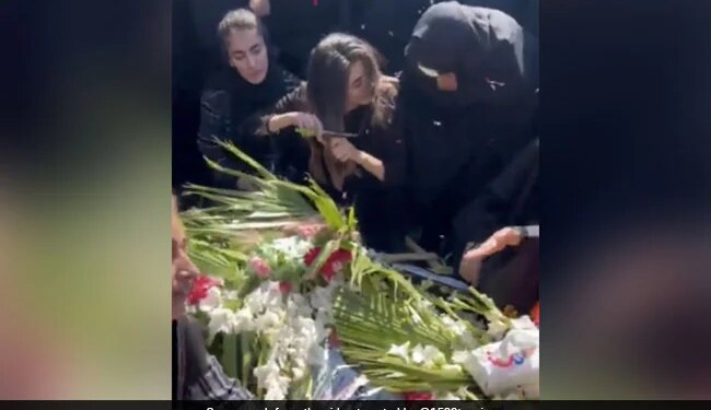 Mahsa Amini Death: Grieving Sister Of Iran Man Killed In Protests Chops Hair At His Funeral | Woman Chops Hair On Grave Of Brother Killed In Iran Protest