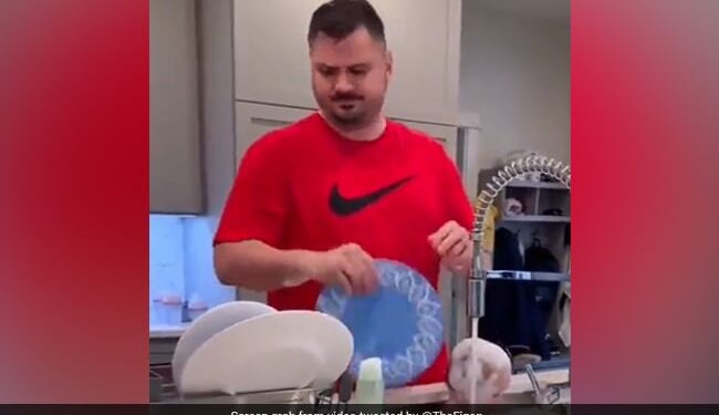 Father Washing Dishes Together While Bathing The Baby In The Sink Funny Video Goes Viral