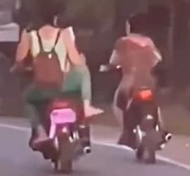 Girl Falls While Trying To Kick A Bike Rider Video Viral, Woman Falls While Trying To Kick Bike Rider