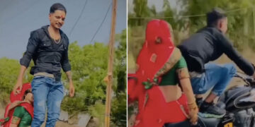 Husband Doing Stunt While Wife Sitting On His Bullet Left The Handle And Stood On The Seat See Shocking Video – पत्नी को बुलेट पर बैठाकर ‘खतरों के खिलाड़ी’ बना शख्स, हैंडल छोड़ सीट पर खड़ा हो गया, लोग बोले