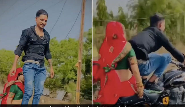 Husband Doing Stunt While Wife Sitting On His Bullet Left The Handle And Stood On The Seat See Shocking Video – पत्नी को बुलेट पर बैठाकर ‘खतरों के खिलाड़ी’ बना शख्स, हैंडल छोड़ सीट पर खड़ा हो गया, लोग बोले